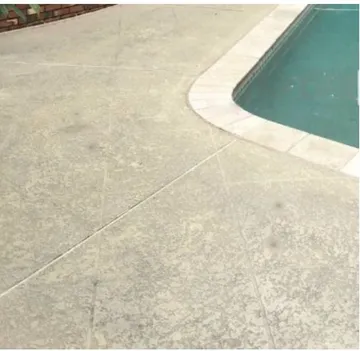 After: concrete pool deck beside a pool